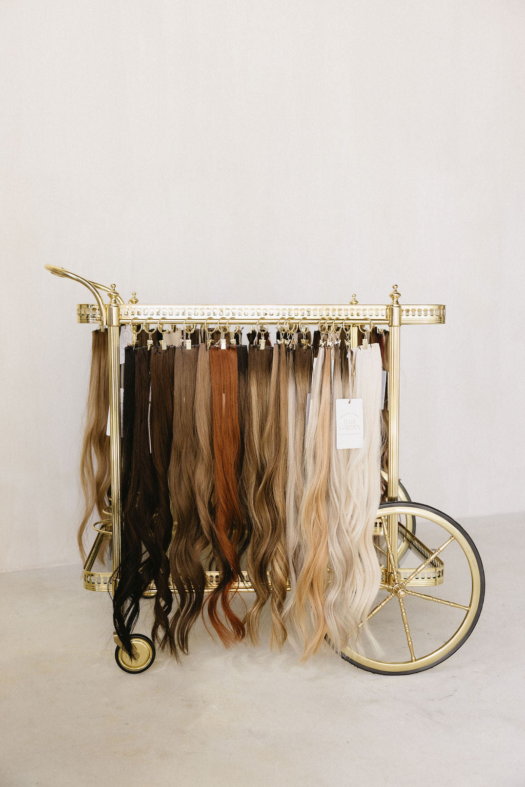 Hand-tied wefts hung on a brass cart